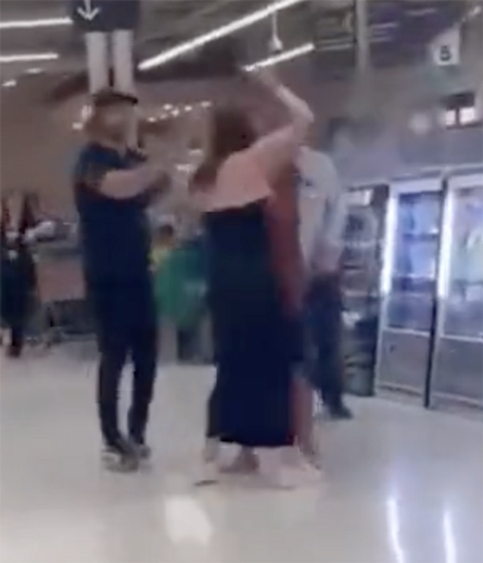 Wild supermarket brawl includes one woman handing her baby to a stranger before dropping bombs